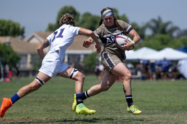 Army Staff Sgt. Erica Myers fends off a tackle during the 2024 Armed Forces Women’s Rugby Championships in San Diego, Calif. July 12, 2024. (DoD photo by EJ Hersom)