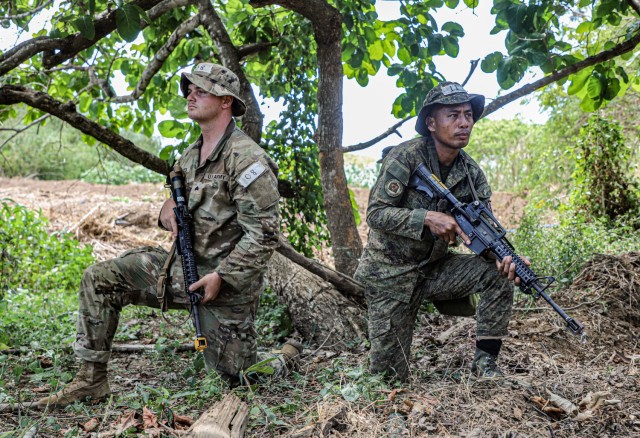 U.S. Army Sgt. Bradley Bates, assigned to Charlie Company, 2nd Battalion, 27th Infantry Regiment, 3rd Infantry Brigade Combat Team, 25th Infantry Division, provides security alongside Philippine Army Sgt. Ryel Agawayas, assigned to the 7th...