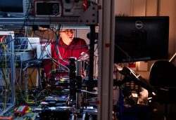 Sandia physicist works on a photonic integrated chip.