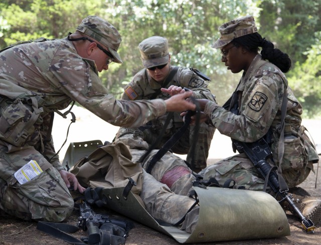 Cadet Rebecca Karis works with her fellow cadets on applying  life-saving first aid techniques to ensure battle buddy survivability on the modern battlefield during Phase II of Advance Camp at Cadet Summer Training on Fort Knox, Kentucky, July 19,...