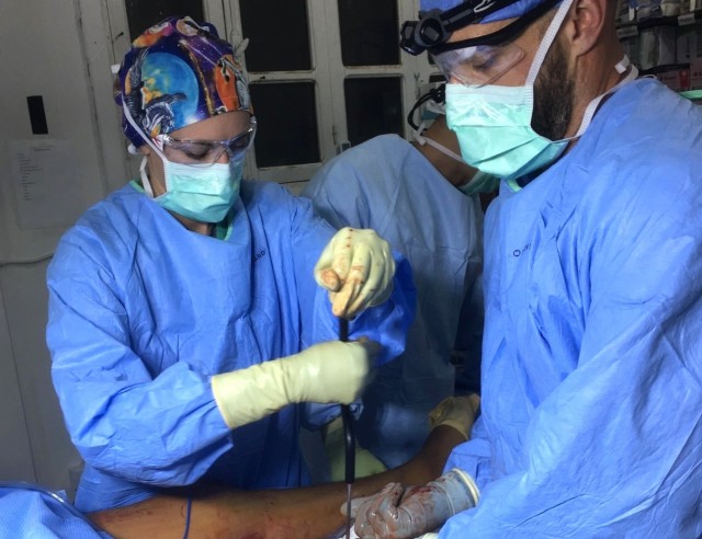 Lt. Kelly K. Spencer, Army nurse, assists with a surgical procedure during a 10-month deployment to Syria in 2018. She worked on a small team and had to challenge herself to step out of her comfort zone.