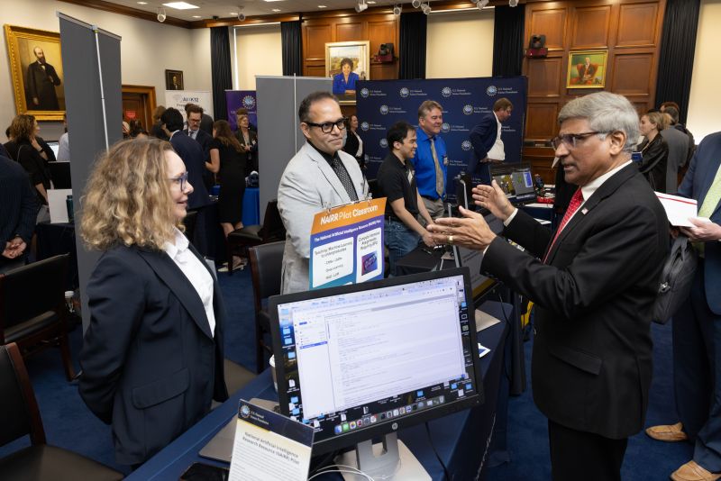 man interacting with people visiting a table