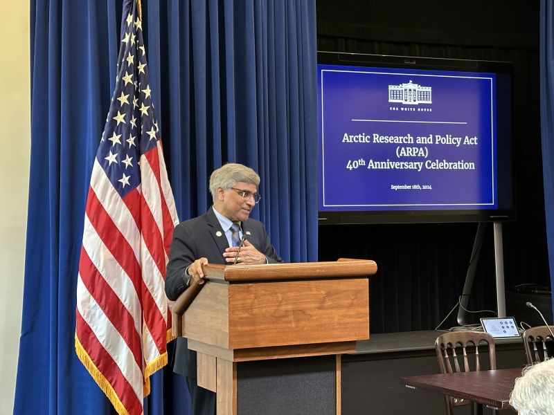 man speaking at podium