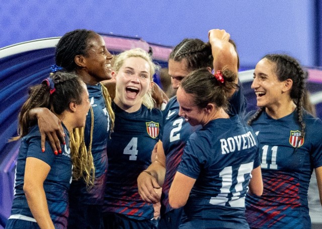 Capt. Samantha "Sammy" Sullivan, third from left, celebrates with her team during the U.S. quarterfinal victory over Great Britain. Sullivan scored on a late try to seal the 17-7 win.