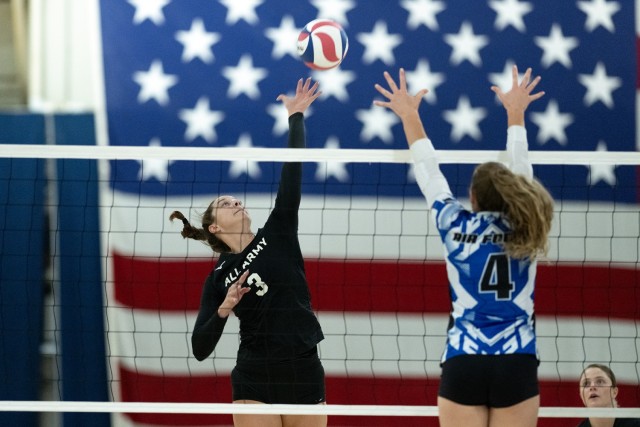 Capt. Sydney Morriss, a right side hitter on the All-Army women's volleyball team, tips the ball over the net during Army's match with the All-Air Force team on Sept. 13. The All-Army women's team won its first Armed Forces tournament...