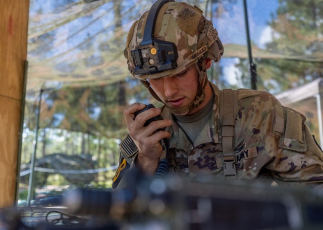 Spc. Gage Buck, an infantryman assigned to the 25th Infantry Division and representing the U.S. Army Pacific radios in the location of a simulated artillery strike during the call for fire lane portion of the Expert Soldier Badge testing during...