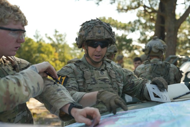 Sgt. 1st Class Alexander Haynes, the Noncommissioned officer of the year representing the U.S. Army Medical Command Best Squad Team, studies a map during the call for fire event for the Army Best Squad Competition at Fort Liberty, North Carolina,...