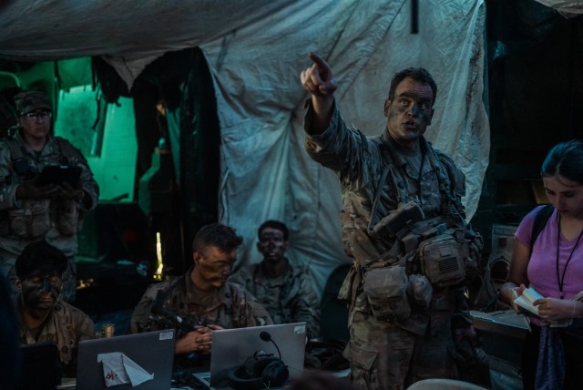 Col. James Stultz, commander of the 2nd Mobile Brigade Combat Team, briefs generals and the press about the capabilities of the 101st Airborne Division's command post during a training exercise at the Joint Regional Training Center on Fort...