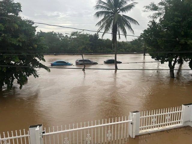 In the aftermath of Hurricane Fiona, floodwater flows near the house of Spc. Julymar Otero's mother, Dagmar Perez, in Toa Baja, Puerto Rico.