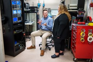 Sandia National Laboratories scientists Alex Bates and Loraine Torres-Castro talk about positioning a battery that’s undergoing testing at the Battery Abuse Testing Lab. Their research on electric vehicle batteries aims to detect battery failures more quickly. (Photo by Craig Fritz) Click on the thumbnail for a high-resolution image.