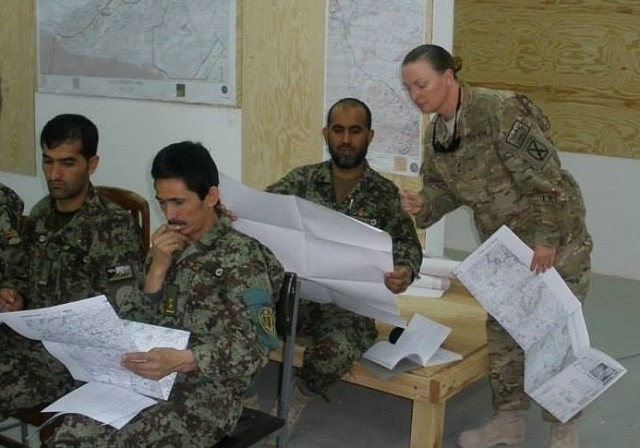 Master Sgt. Melissa O'Brien goes through map reading training with members of the Afghan army during a deployment to Kandahar in 2011. This deployment reinvigorated her passion for the Army and she went on to serve another 10 years.