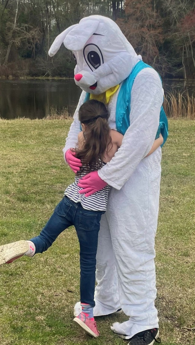 Liam Messenger, 15, son of Lt. Col. Tony Messenger, 3rd Squadron commander, Second Security Force Assistance Brigade, Fort Liberty, North Carolina, receives a hug from a military family member during an Easter family event on Fort Jackson, South...