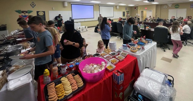 Families of drill sergeants at Fort Jackson, South Carolina, enjoy a potluck dinner as part of the first 72 hours. Lt. Col. Tony Messenger, 3rd Squadron commander, Second Security Force Assistance Brigade, Fort Liberty, North Carolina, and his...