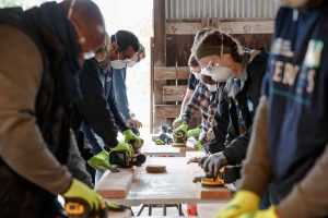 Sandia National Laboratories employees in California sand 2x4’s as part of a project to build beds for the organization Sleep in Heavenly Peace. (Photo by Spencer Toy) Click on the thumbnail for a high-resolution image.