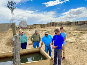 Sandia National Laboratories geotechnology systems engineer Brian Dwyer collects a water sample from a cattle drinker on the Navajo Nation as part of an NMSBA project with Remote Well Solutions. (Photo by Brian Dwyer/Sandia National Laboratories) Click on the thumbnail for a high-resolution image.