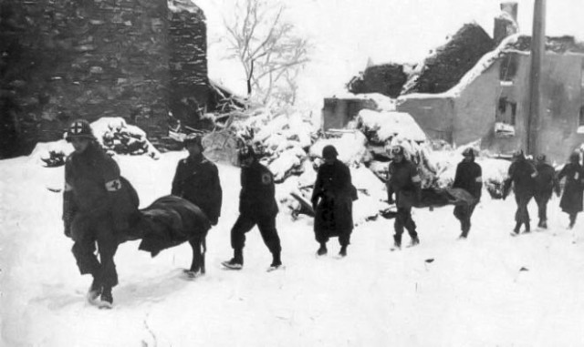 Medics with Company A, 110th Medical Battalion, evacuate wounded during the Battle of the Bulge near Lutrebois, Belgium, in January 1945.