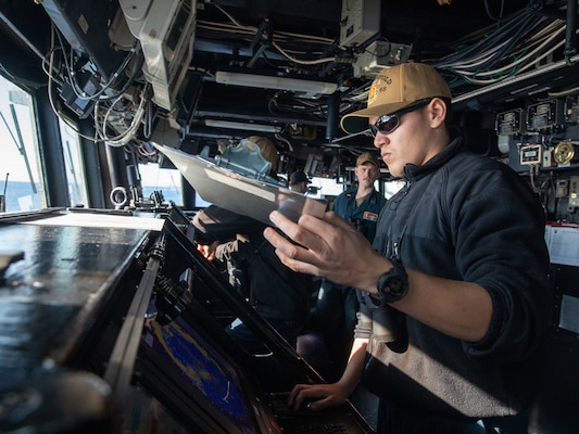 Ensign Christian Dean checks for radar contacts during a sea and anchor evolution aboard USS Benfold (DDG 65) while preparing to depart Yokosuka, Japan.