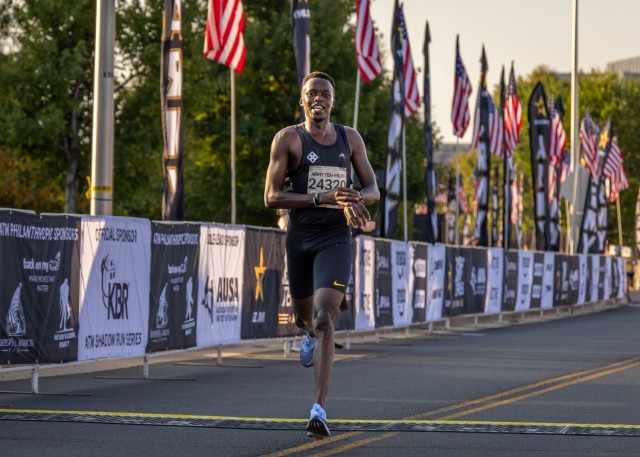 Spc. Geoffrey Kipchumba, a behavioral health specialist assigned to the Embedded Behavioral Health Team Aviation, 4th Combat Aviation Brigade, 4th Infantry Division, crosses the finish line during the 2024 Army Ten-Miler, Oct. 13, 2024, at...